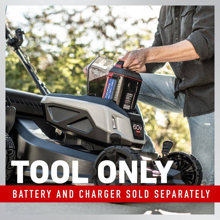 Toro 21568T tool-only mower close-up showing a battery being inserted; graphic states battery and charger sold separately.